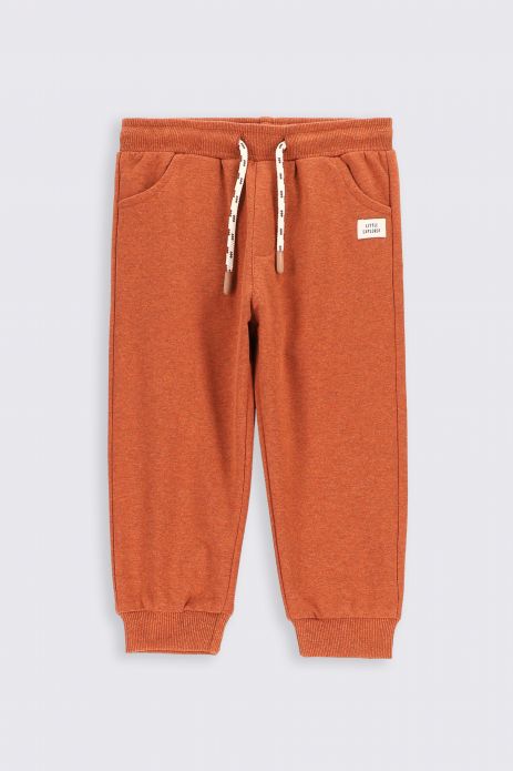 Sweatpants orange with print and a teddy bear imprint